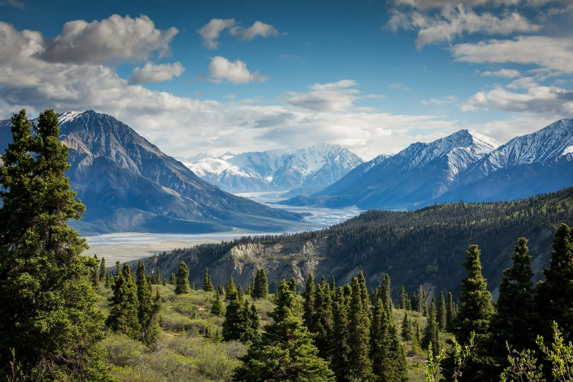 A serene alpine valley beneath soaring mountain peaks